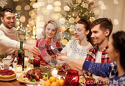 Friends celebrating christmas and drinking wine Stock Photo