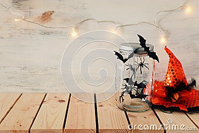 Holidays image of Halloween. bats, witch hat over wooden table Stock Photo