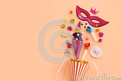 Holidays image of mardi gras masquarade mask and streamers over pastel background. view from above Stock Photo