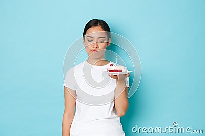 Holidays, lifestyle and celebration concept. Skeptical and disappointed asian girl in white t-shirt, complaining over Stock Photo