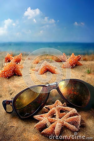 Holidays. sand beach, sunglasses and starfish Stock Photo