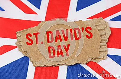 Against the background of the flag of Great Britain lies cardboard with the inscription - St. Davids Day Stock Photo