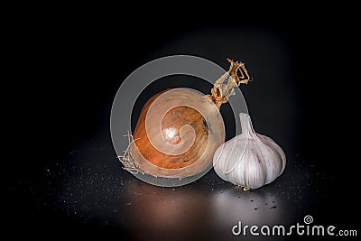 Holland Onions and galic on a black background with low light.. Stock Photo