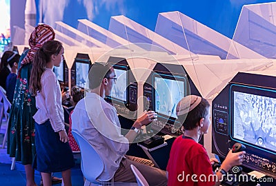 Visitors use visual simulators under the supervision of an army instructor at the army exhibition `Our IDF` Editorial Stock Photo