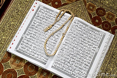 Holy Al Quran and prayer beads on the prayer mat Editorial Stock Photo