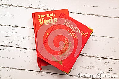 Holy Bhagavad gita and The Holy Veda the oldest scriptures of Hinduism on wooden textured background Editorial Stock Photo