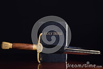 The Holy Bible with Ancient Sword Stock Photo