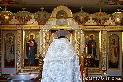 Holy Bible, Orthodox cross and Bowl prepared for christening ceremony Editorial Stock Photo