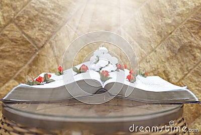 Holy Bible Scriptures With Beautiful Flowers And Heavenly Light Beams Stock Photo