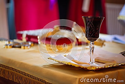 Holy communion wine glass and bread during wedding traditional ceremony in church Stock Photo