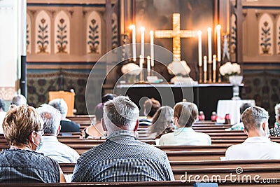 Holy mass in Christian church during the coronavirus pandemic Covid-19. Safe personal distance with protective masks Editorial Stock Photo