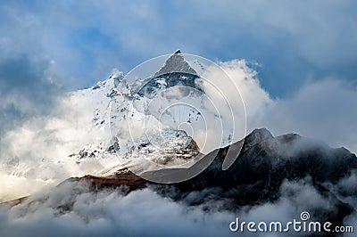 Machapuchare, Fish Tail Mountain rising above the clouds from the Annapurna base camp trail, Nepal Stock Photo