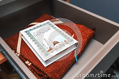 Holy Muslim Quran and special mat for prayer and namaz. Concept of the religion of Islam Editorial Stock Photo