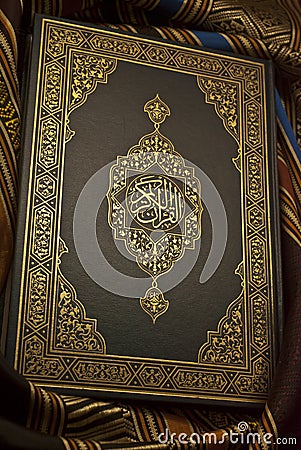 Intricate Beauty: The Holy Quran on Arabic Art Cloth Stock Photo