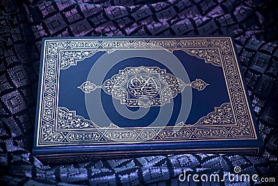 Quran under Moonlit Hue Stock Photo