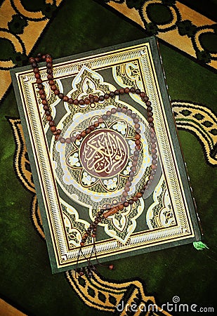 Holy Quran Book With Rosary Stock Photo