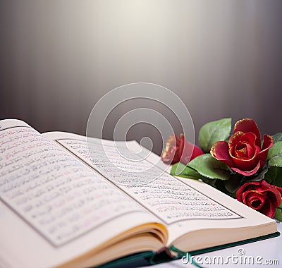 Holy Quran and roses. Stock Photo