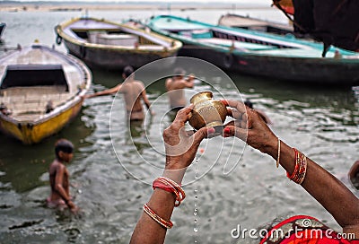 The holy river . A lady offering holy water to mother Ganga. Editorial Stock Photo