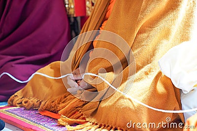 holy thread in monk hands Stock Photo
