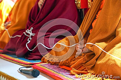 holy thread in monk hands Stock Photo