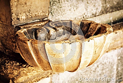 Holy water font, yellow filter Stock Photo