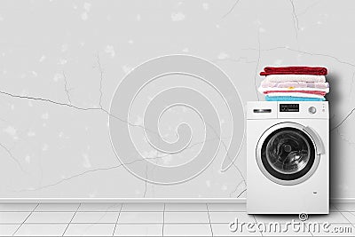 Home appliance - Washing machine and linen pile in home interier Stock Photo