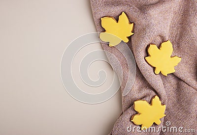 Home autumn background of yellow gingerbread leaves on a soft wool blanket top view, space for text Stock Photo