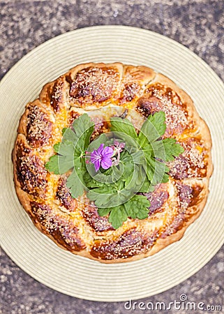 Home baked holly easter bread decorated with fresh flowers and caster sugar Stock Photo