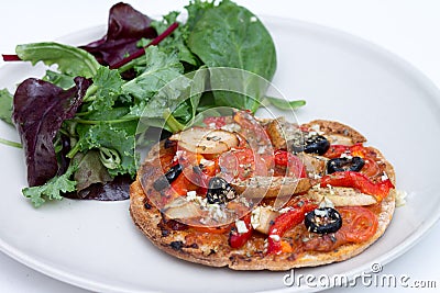 Home baked vegan mini pizza with ruccola salad Stock Photo