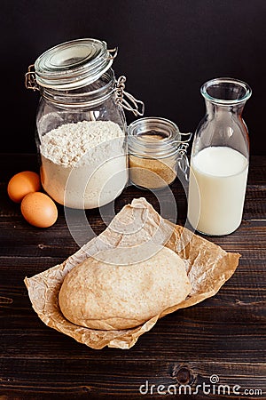 Home baking. Baking ingredients with dough on the wooden table Stock Photo