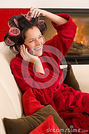 Home beauty woman with hair curlers calling Stock Photo