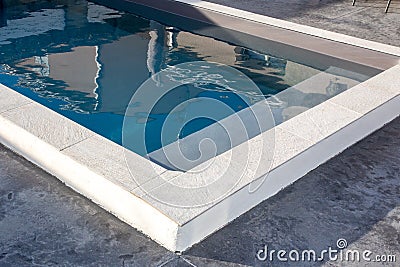 Home blue swimming pool with stone coping with a waxed concrete terrace house Stock Photo