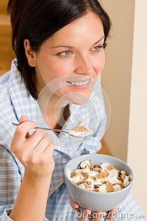 Home breakfast happy woman pajamas eating cereals Stock Photo