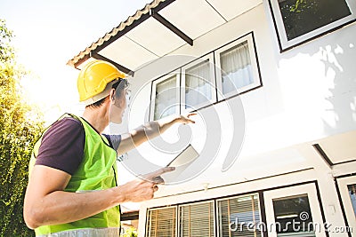 The home builder carries a tablet to check the finish before handing it over to the landlord. Stock Photo