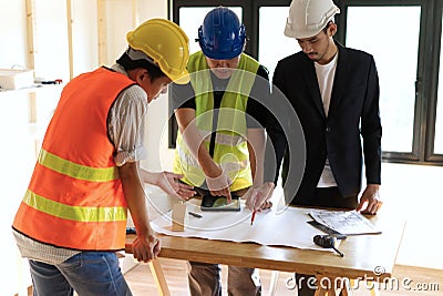 Home building members gathering on working table having some discussion for project planning. Stock Photo