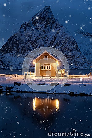 Home, cabin or house at night, Norwegian fishing village in Reine City, Lofoten islands, Nordland county, Norway, Europe. White Stock Photo
