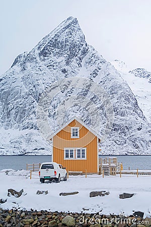 Home, cabin or house, Norwegian fishing village in Reine City, Lofoten islands, Nordland county, Norway, Europe. White snowy Stock Photo