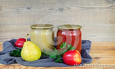 Home canning: pear puree, and tomato juice. Stock Photo