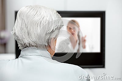 In-home care for an elderly patient with telemedicine or telehealth, virtual live chat Stock Photo