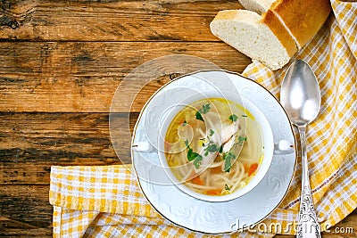 Home chicken soup with noodles, vintage spoon, tablecloth Stock Photo