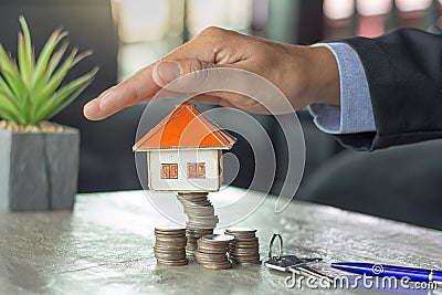 Home on coins stack, Property investment and house mortgage financial. Risk management concept. Stock Photo