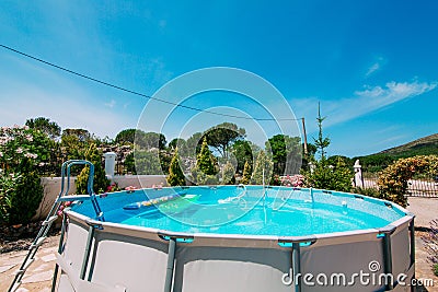 Home collapsible pool. A small rubber swimming pool within the c Stock Photo