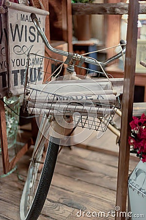 Home decor shop using a vintage bicycle wire basket to display t Stock Photo