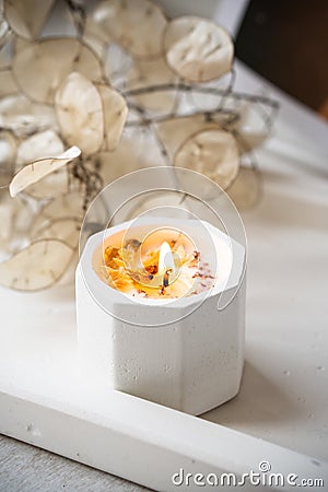 Home decoration with burning aromatic candle, white interior decor Stock Photo