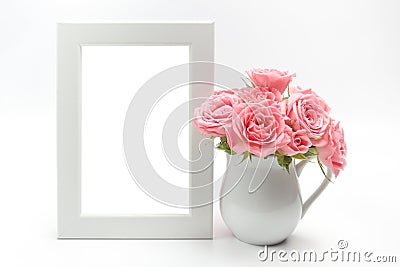 Home decoration, picture frame and cup with roses Stock Photo