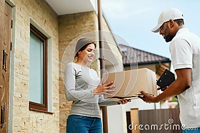 Home Delivery. Courier Delivering Package To Client Stock Photo