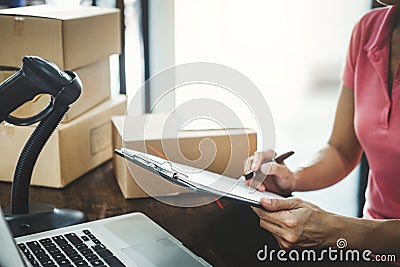 Home delivery service and working service mind, Woman working checking order to confirm before sending customer in post office Stock Photo