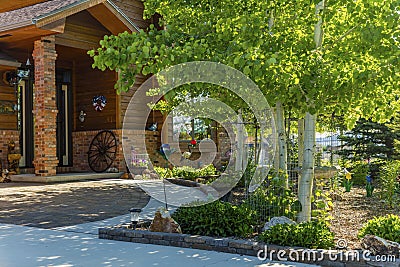 Home entrance brick redwood siding aspen landscaping Stock Photo