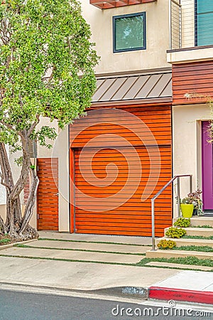 Home exterior with brown garage door and roof overhang in Long Beach California Stock Photo