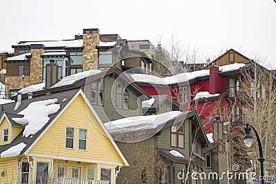 Home exteriors with horizontal wall siding and thick snow on the roofs Stock Photo